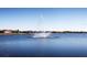 Picturesque lake featuring a water fountain, surrounded by luxurious homes, set in a peaceful community at 16614 Berwick Ter, Lakewood Ranch, FL 34202