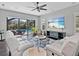 Spacious living room boasts a ceiling fan, comfortable seating, and views of the screened-in lanai and pool at 16614 Berwick Ter, Lakewood Ranch, FL 34202