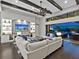 Bright living room with beamed ceilings, stone fireplace, and seamless indoor/outdoor flow to the pool area at 16614 Berwick Ter, Lakewood Ranch, FL 34202
