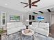 Bright living room featuring comfortable seating, a ceiling fan, and modern decor at 16614 Berwick Ter, Lakewood Ranch, FL 34202