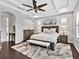 Inviting main bedroom with tray ceiling, ceiling fan, and luxury accents and furniture at 16614 Berwick Ter, Lakewood Ranch, FL 34202