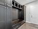 Mudroom featuring built-in storage cabinets, a bench and drawers, and wood flooring at 16614 Berwick Ter, Lakewood Ranch, FL 34202