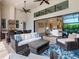 Expansive outdoor living space featuring a full kitchen, bar seating, and comfortable lounge areas at 16614 Berwick Ter, Lakewood Ranch, FL 34202