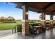 Inviting outdoor seating area with comfortable wicker chairs overlooking the scenic golf course and beautiful landscaping at 16614 Berwick Ter, Lakewood Ranch, FL 34202