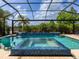 Stunning pool and spa area with water features, lush landscaping, and serene lake views at 16614 Berwick Ter, Lakewood Ranch, FL 34202