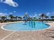 Shallow entry community pool featuring water playground features and a brick paver deck with beach access at 16614 Berwick Ter, Lakewood Ranch, FL 34202