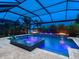 An inviting screened-in pool and hot tub, complete with lighting and views of the lake at 16614 Berwick Ter, Lakewood Ranch, FL 34202