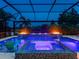 Enclosed pool with a spa, water features, fire bowls, and lounge chairs at twilight at 16614 Berwick Ter, Lakewood Ranch, FL 34202