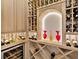 Close-up of the custom wine cellar, including lit display areas and wine fridge at 16614 Berwick Ter, Lakewood Ranch, FL 34202