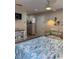 Bright bedroom with a queen bed, couch, and bright lighting at 170 Roosevelt Dr # 5, Sarasota, FL 34236
