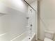 This bathroom features a shower-tub combo with white tiled walls and a sleek design at 17124 Harvest Moon Way, Lakewood Ranch, FL 34211