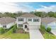 Two-story home featuring a manicured lawn, neutral paint, dark shutters, and a two-car garage at 17124 Harvest Moon Way, Lakewood Ranch, FL 34211
