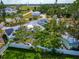 Aerial view showcasing this property in a quiet neighborhood, surrounded by mature trees at 1722 Hazelwood St, Sarasota, FL 34231
