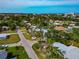 High angle shows a beautiful home surrounded by lush greenery and distant views at 1722 Hazelwood St, Sarasota, FL 34231