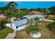 Bird's-eye view of a well-maintained home with a circular driveway, solar panels, and lush landscaping at 1722 Hazelwood St, Sarasota, FL 34231