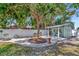 Backyard area featuring decorative seating, a shed, and mature trees providing ample shade at 1722 Hazelwood St, Sarasota, FL 34231