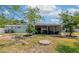 Expansive backyard featuring a screened patio, manicured lawn, and mature landscaping at 1722 Hazelwood St, Sarasota, FL 34231