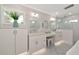 Bright bathroom features dual vanities, makeup counter, patterned tile floor, and glass shower at 1722 Hazelwood St, Sarasota, FL 34231