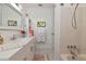 Bright bathroom featuring white cabinets, a white countertop, stylish tile flooring, and shower at 1722 Hazelwood St, Sarasota, FL 34231