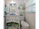Cozy bathroom with a decorative vanity, open shelving and stylish shower curtain at 1722 Hazelwood St, Sarasota, FL 34231