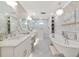 A luxurious bathroom is accented by a clawfoot tub and decorative wallpaper and flooring at 1722 Hazelwood St, Sarasota, FL 34231