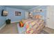 Bright bedroom featuring light blue walls, wood-look floors, and a colorful quilt at 1722 Hazelwood St, Sarasota, FL 34231