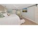 Bedroom with white comforter, a sunset painting and sliding barn doors to another space at 1722 Hazelwood St, Sarasota, FL 34231