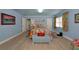 Bright bedroom featuring light blue walls, wood-look floors, a colorful quilt, and plenty of natural light at 1722 Hazelwood St, Sarasota, FL 34231