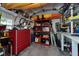 Organized garage space with storage shelving, work bench, tools, bicycle, and kayaks at 1722 Hazelwood St, Sarasota, FL 34231