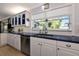 Bright kitchen with stainless steel appliances, white cabinetry, and a modern sink with garden view at 1722 Hazelwood St, Sarasota, FL 34231