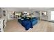 Bright, open-concept living room features a plush blue sectional and flows into dining and kitchen areas at 1722 Hazelwood St, Sarasota, FL 34231