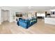 Open-concept living room featuring a plush blue sofa, modern decor, and seamless flow to the dining area at 1722 Hazelwood St, Sarasota, FL 34231