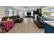 Spacious living room featuring wood-look floors, large windows, comfortable furniture, and exercise equipment at 1722 Hazelwood St, Sarasota, FL 34231