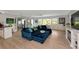 Bright living room with a comfortable blue sectional, large windows, and a stylish, inviting atmosphere at 1722 Hazelwood St, Sarasota, FL 34231
