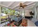 Relaxing screened-in patio featuring comfortable seating, a ceiling fan, and an outdoor television at 1722 Hazelwood St, Sarasota, FL 34231