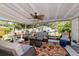 Inviting patio area with cozy seating, a vibrant rug, and a view of the well-maintained backyard at 1722 Hazelwood St, Sarasota, FL 34231