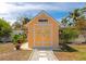 Charming backyard shed with palm tree accents, decorative details, and a well-kept exterior at 1722 Hazelwood St, Sarasota, FL 34231