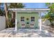 Cozy shed with a seating area, decorated with lights and surrounded by trees at 1722 Hazelwood St, Sarasota, FL 34231