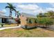 Backyard shed featuring colorful accents, flower boxes, and lush landscaping around the perimeter at 1722 Hazelwood St, Sarasota, FL 34231