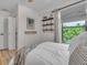 Bedroom with natural light featuring neutral decor, hardwood floors, and a window with green views at 2235 Arlington St, Sarasota, FL 34239