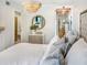 Bedroom features a chandelier, dresser, and a view into an adjacent bathroom and home office at 2235 Arlington St, Sarasota, FL 34239