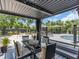 Backyard with an outdoor patio, dining area, hammock, lounge chairs, and in-ground pool at 2235 Arlington St, Sarasota, FL 34239