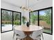 Contemporary dining room featuring sleek lighting, elegant table, and views of the backyard at 2249 Oak Terrace St, Sarasota, FL 34231