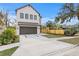 Beautiful home with a two-car garage, modern windows and manicured landscaping at 2249 Oak Terrace St, Sarasota, FL 34231