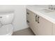Modern bathroom featuring a sleek vanity with counter top and a standard toilet at 2249 Oak Terrace Ter, Sarasota, FL 34231