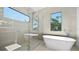 Bright bathroom featuring soaking tub, walk-in shower, large window, and sleek fixtures at 2249 Oak Terrace Ter, Sarasota, FL 34231