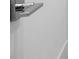 Close-up view of modern door hardware, featuring a sleek silver handle and a minimalist design at 2249 Oak Terrace Ter, Sarasota, FL 34231