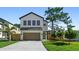 Modern two-story home with a two-car garage, manicured lawn, and well-maintained landscaping at 2249 Oak Terrace Ter, Sarasota, FL 34231