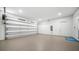 Spacious garage with a roll-up door, offering ample parking and storage space at 2249 Oak Terrace Ter, Sarasota, FL 34231