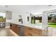 Kitchen island featuring light wood base, white countertop, faucet, and stainless-steel dishwasher at 2249 Oak Terrace Ter, Sarasota, FL 34231